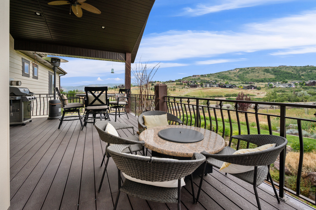 Expansive covered deck with breathtaking mountain of Snowbasin Mountain — the perfect spot for morning coffee or evening sunsets. Enjoy the fire table for evening entertainment.