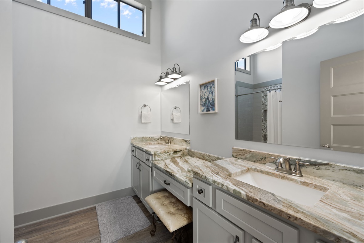 Spacious Master bathroom with dual vanities, stone countertops, and plenty of room to get ready comfortably.