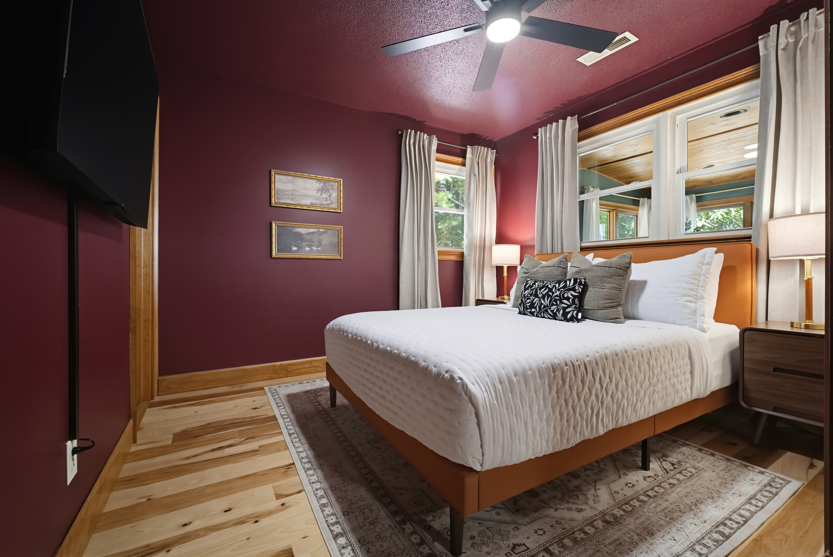 {Bedroom 2} Wrapped in warm tones with peaceful woodland views, this inviting Queen Ensuite offers a quiet place to relax and recharge between adventures.