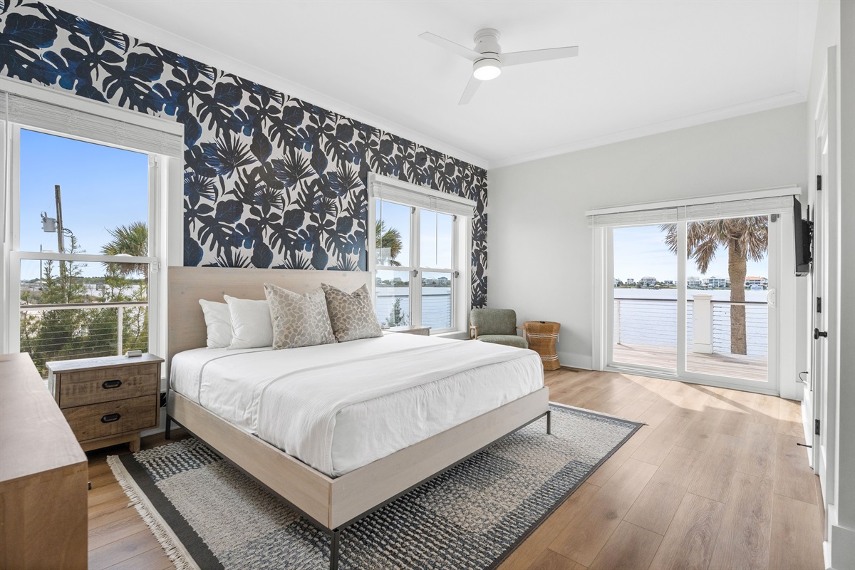 Spacious 1st-floor king master suite with private deck access, waterfront views, and a luxurious ensuite bathroom
