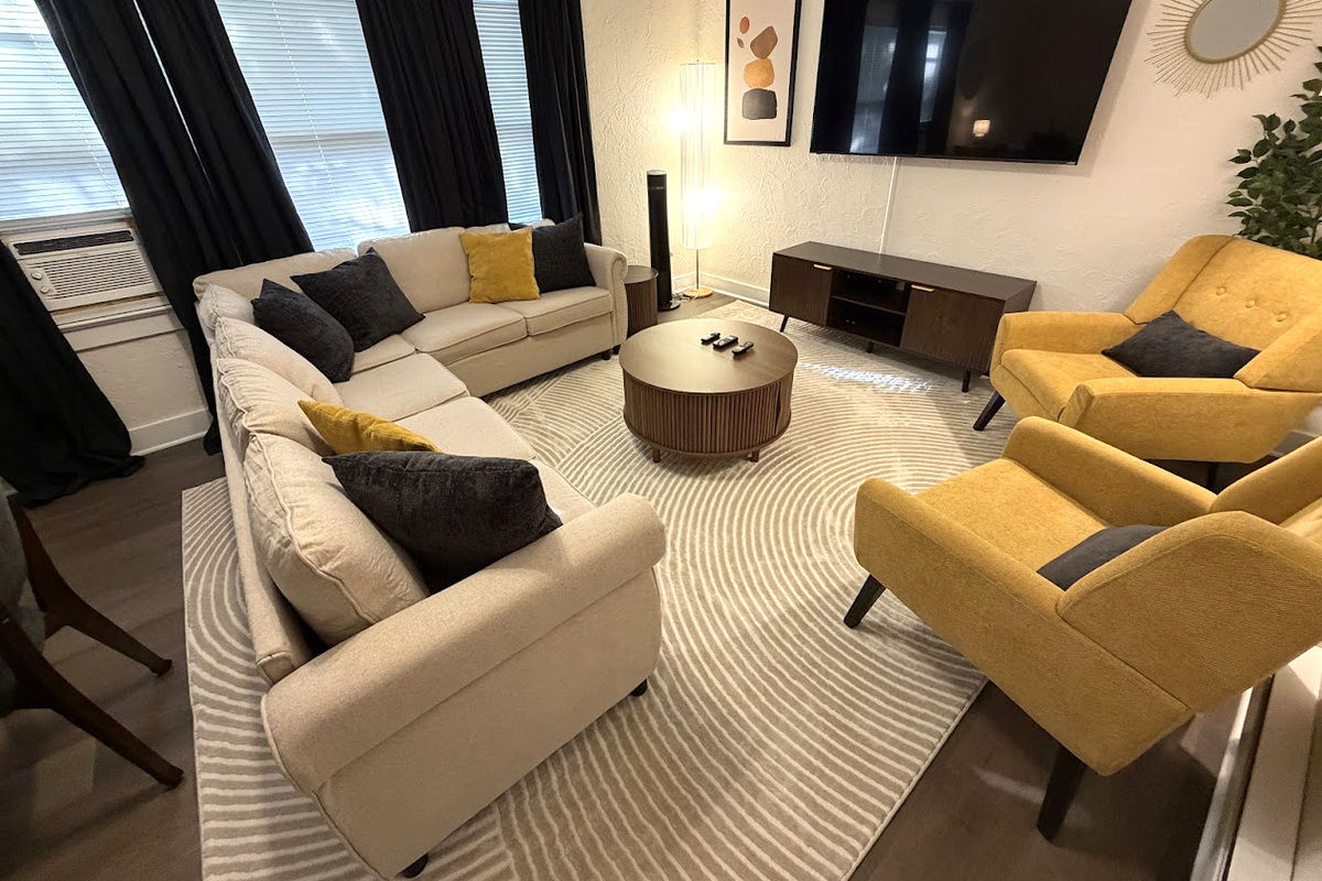 Living Area w/ 65" Smart TV and pull-out sofa bed