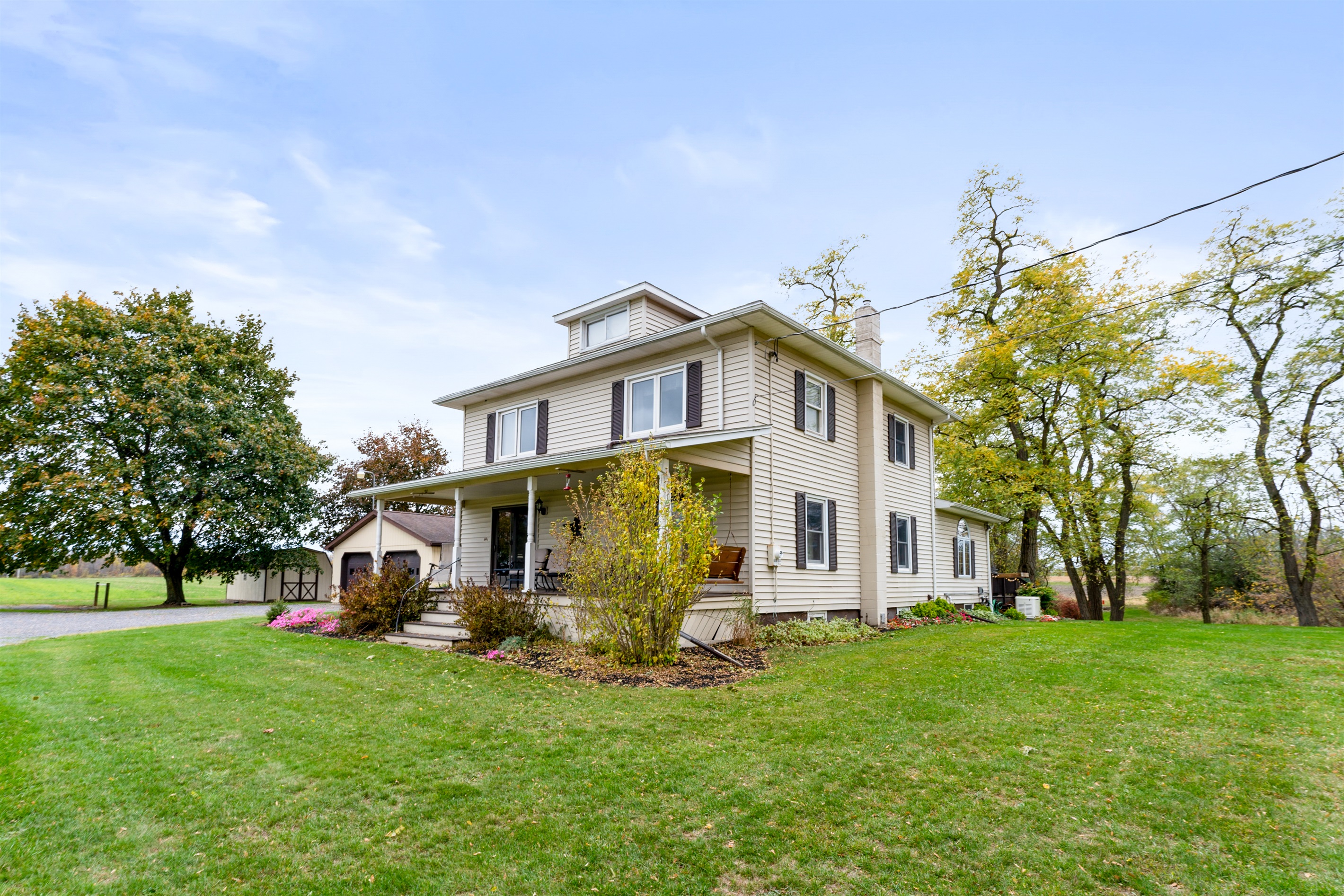 Classic farmhouse style meets modern comfort in a scenic setting