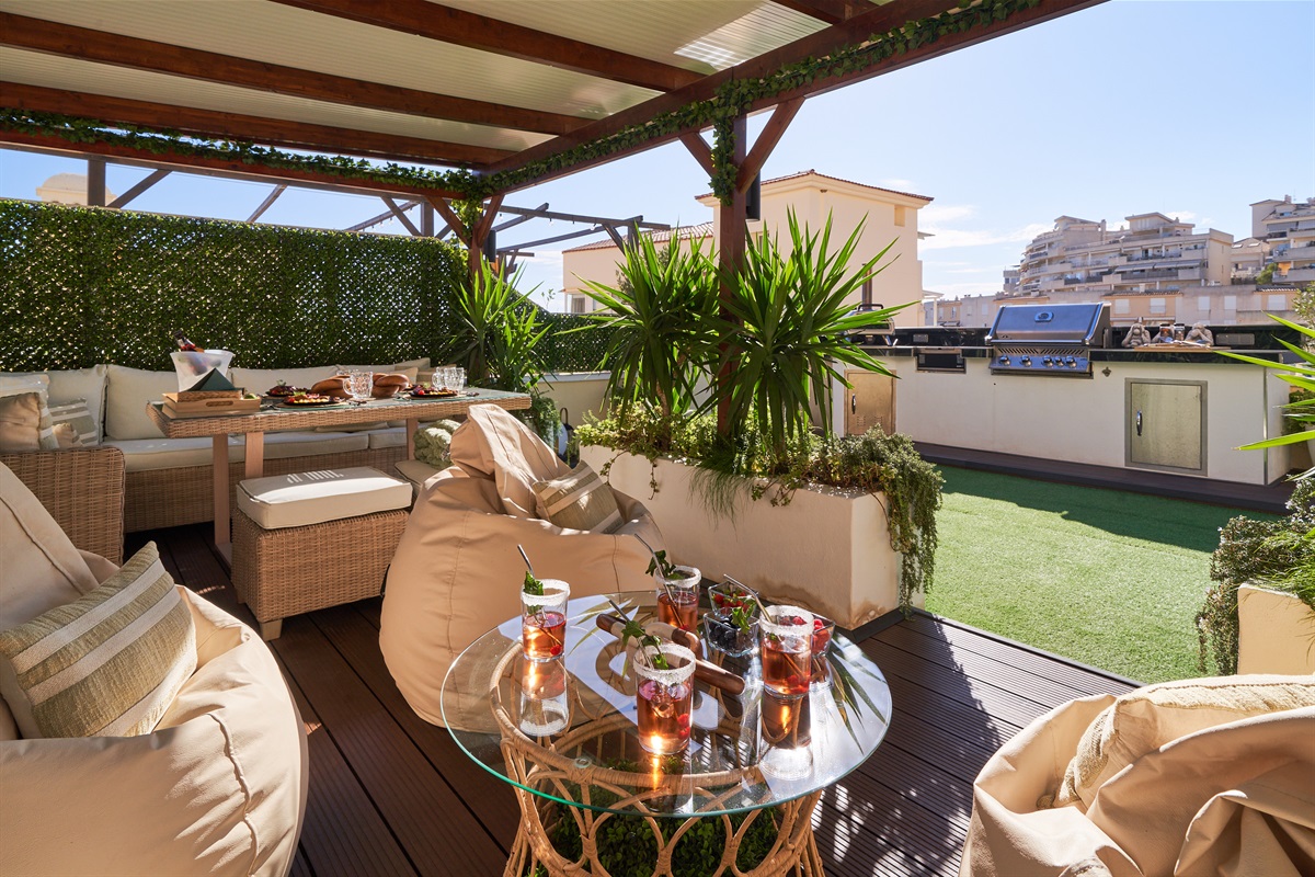 Relax beneath the covered pergola with cozy seating, fireplace, and dining area. Perfect for long evenings, romantic dinners, or movie nights on the outdoor TV under soft ambient lights.