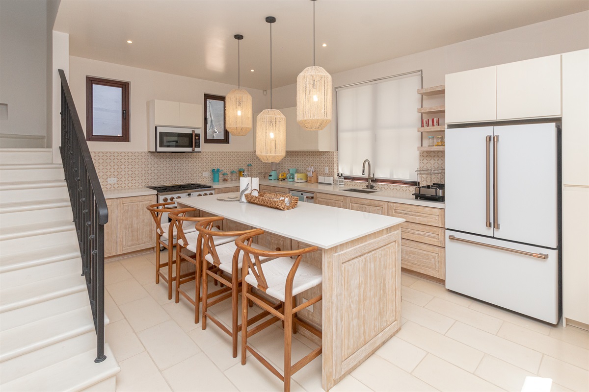 Located in the right wing of the home, the fully equipped kitchen has a gas stove and large island perfect for gathering.