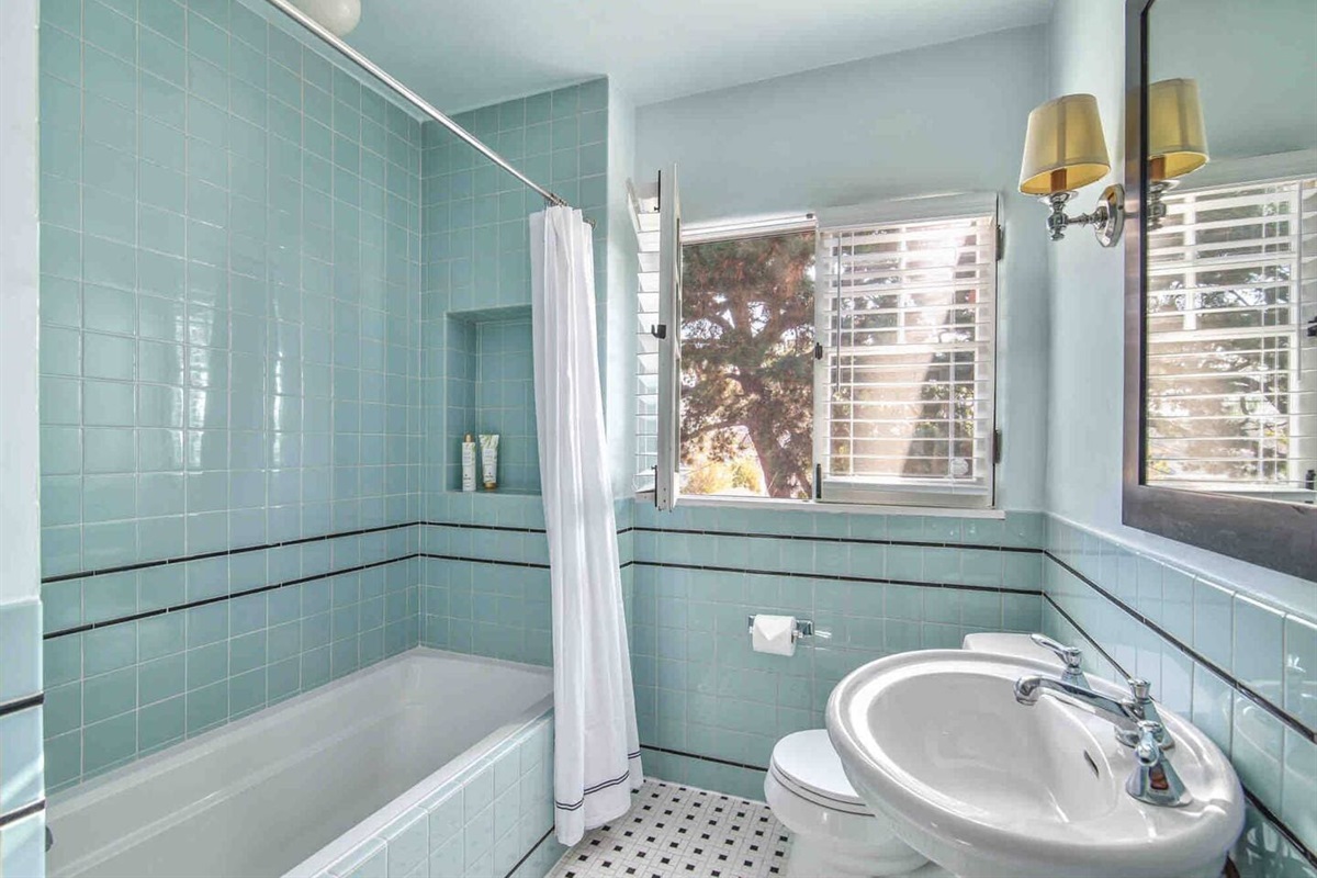 Tub/shower full bathroom down a short hall adjacent to the primary bedroom. 