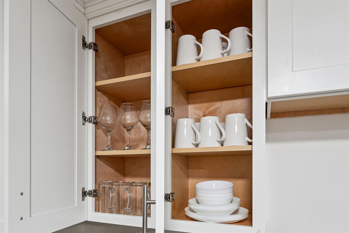 Full kitchen thoughtfully stocked with everything you may need including cookware, utensils, dishes, and essential appliances perfect for preparing meals and enjoying a true home-away-from-home experience.
