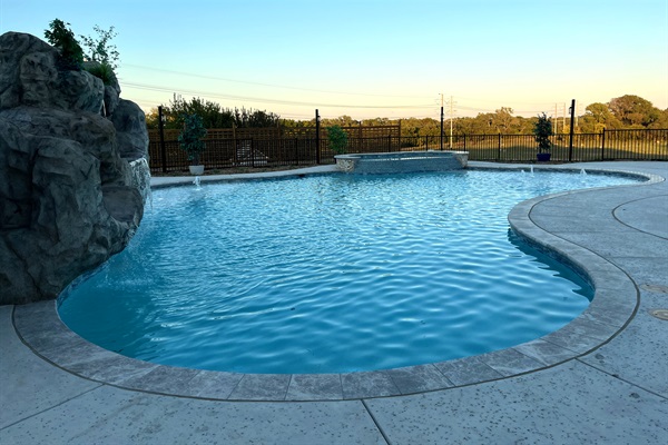 Resort style 30,000-gallon saltwater pool with double waterfalls and grotto and slide