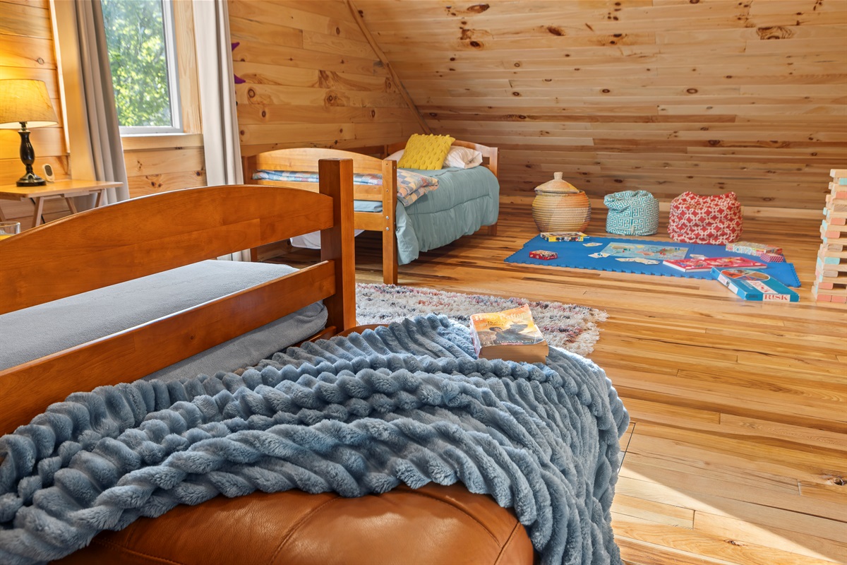 Loft Bedroom 4: Bright, fun retreat with playful decor and game area for family adventures!