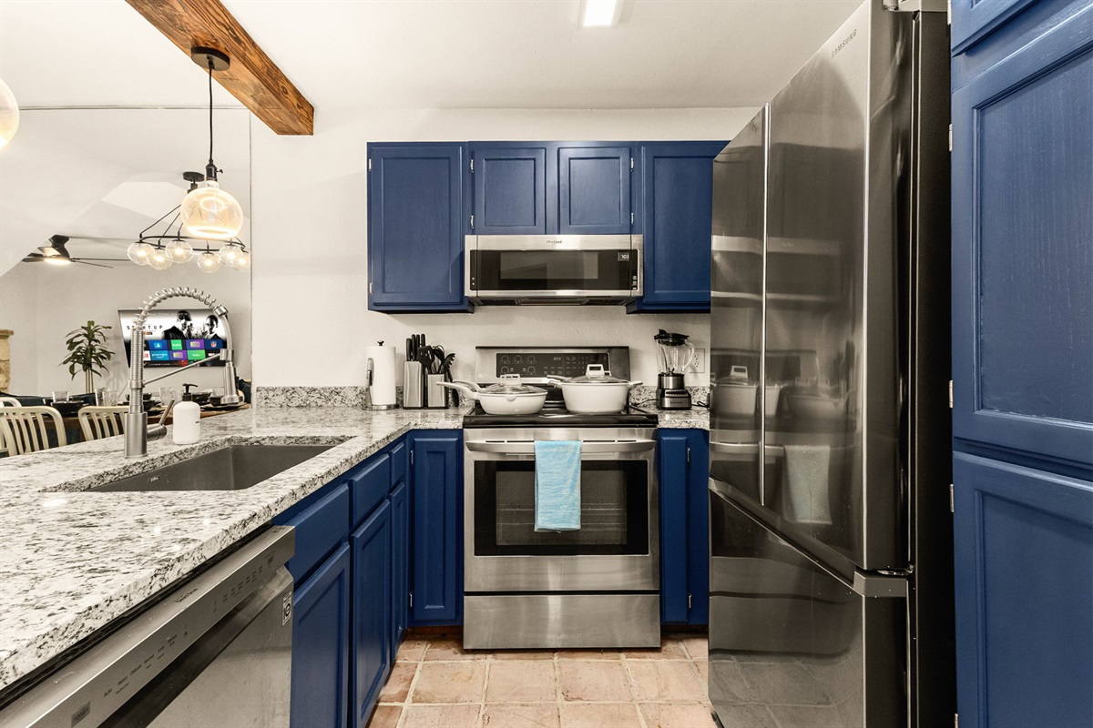 Kitchen workspace with beautiful blue cabinetry and modern appliances