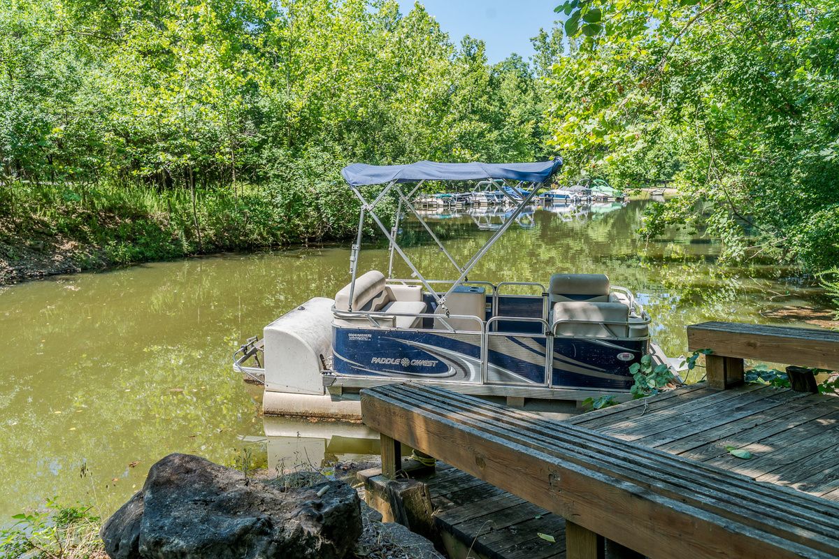 Your Paddle Pontoon seats 6 — canopy overhead, helm ready, and open water waiting whenever you want it.
