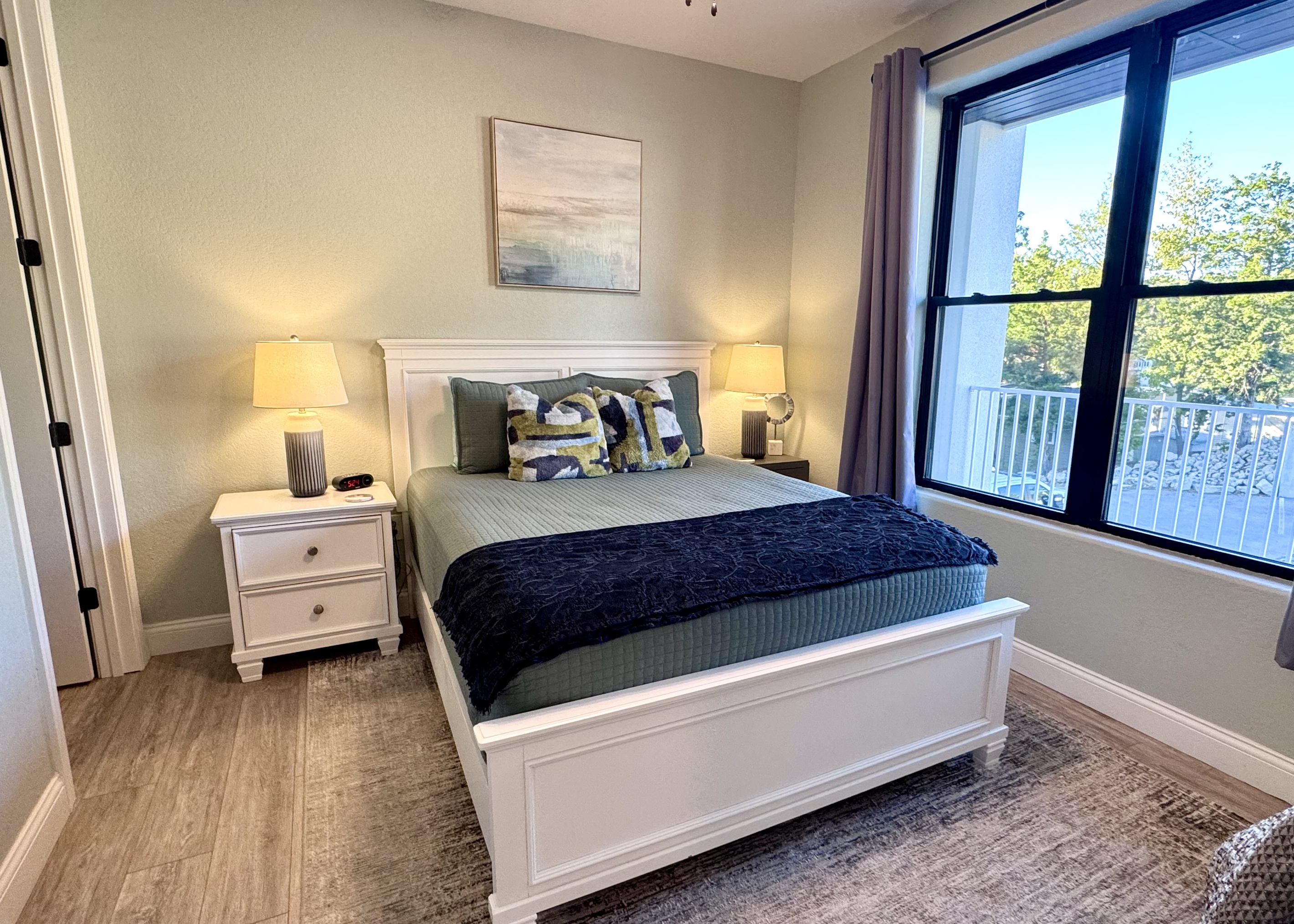 Bedroom 3 has a comfy queen bed, RokuTV, closet, two nightstands, table lamps, a dresser, an alarm clock, all bedding linens, extra pillows, a blanket, and an extra set of sheets.