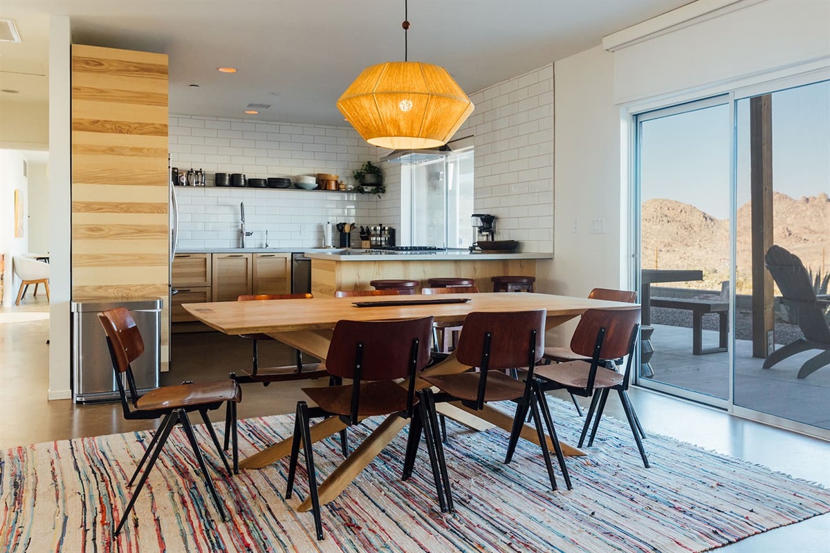Open plan dining room with large table that seats 8. The table extends and extra chairs are available.
