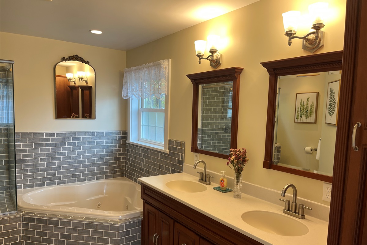 Primary bath with jetted tub and frameless glass shower