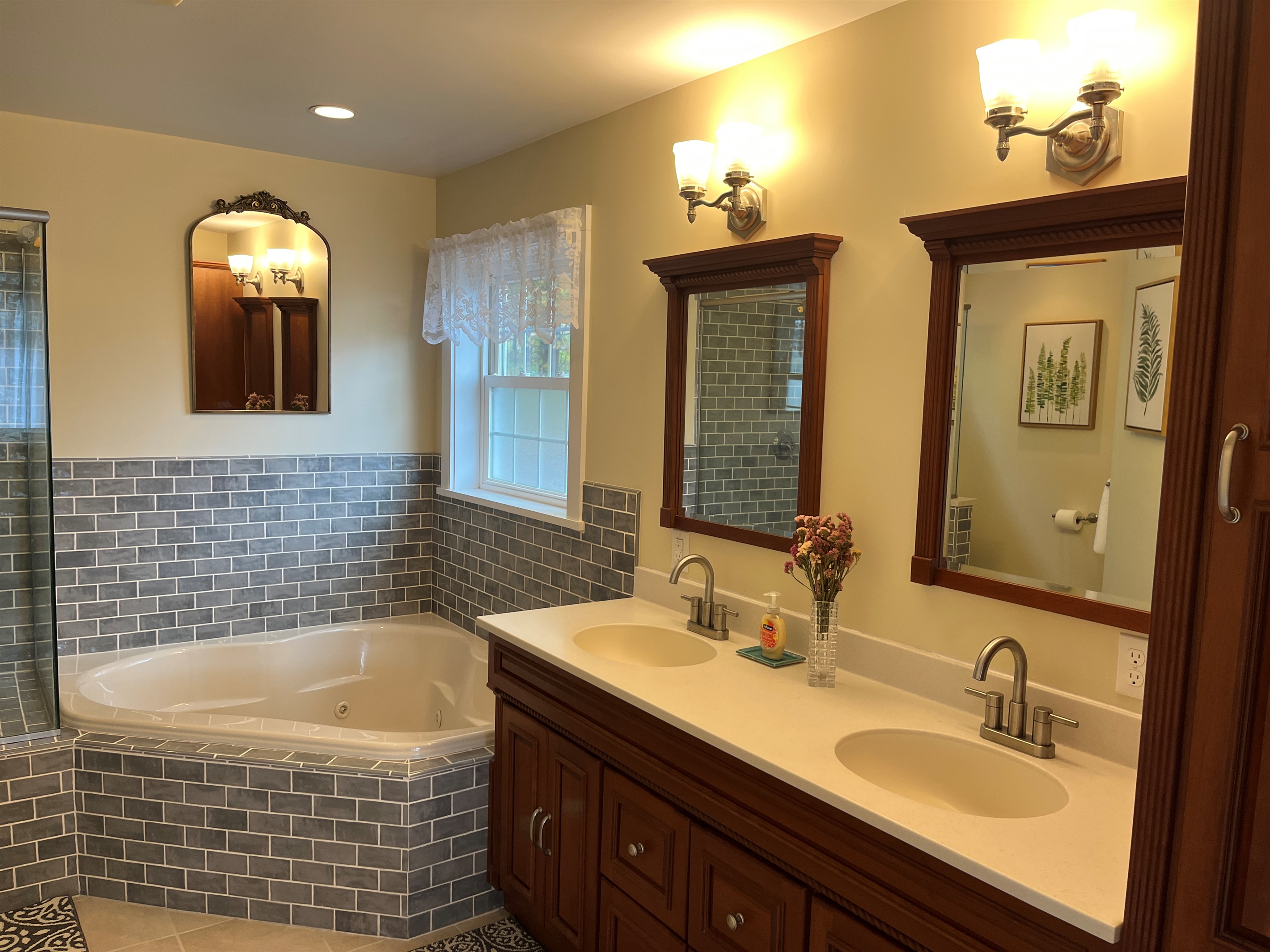 Primary bath with jetted tub and frameless glass shower