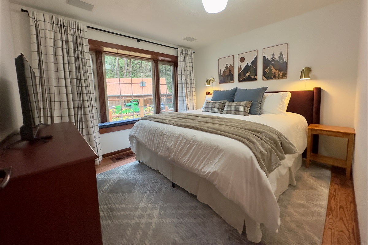 Bedroom 6 is located on the main level of the main house and offers a cozy king bed, large windows, and 43" Roku TV.