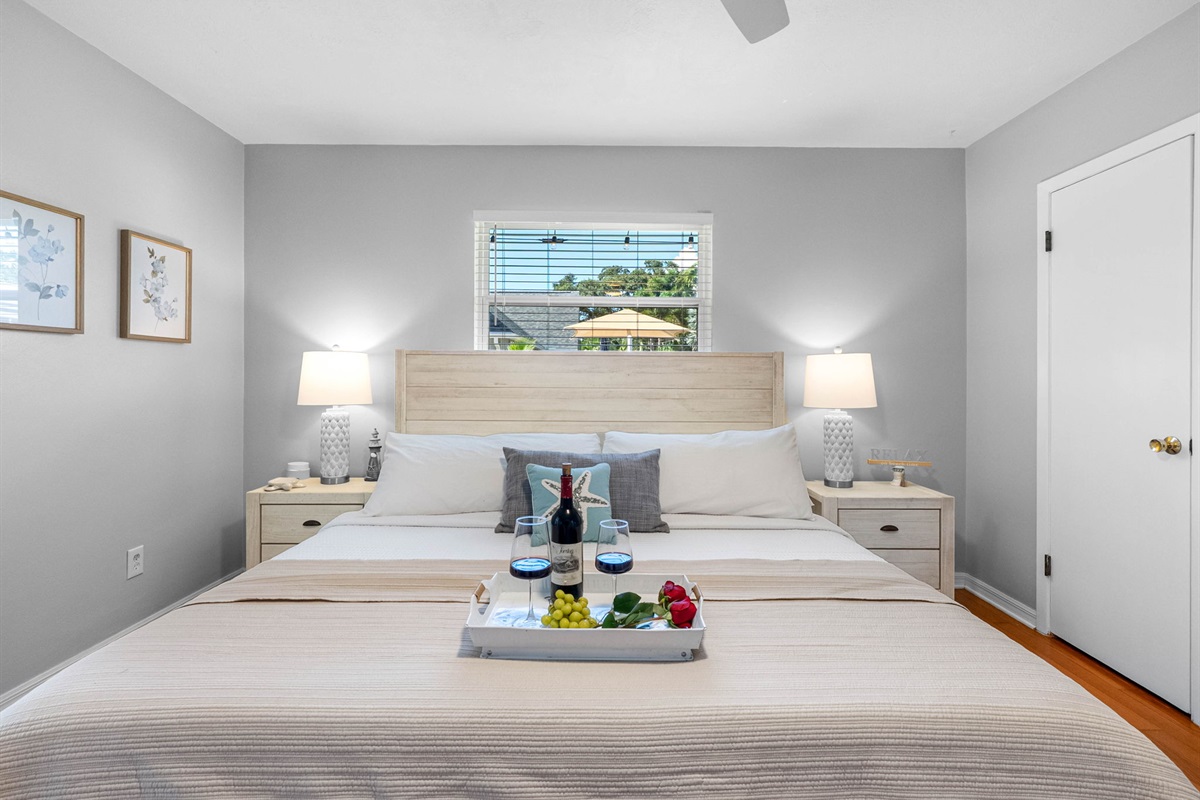 Retreat to the master bedroom, where a plush king mattress, modern ceiling fan, and calming decor invite pure relaxation.