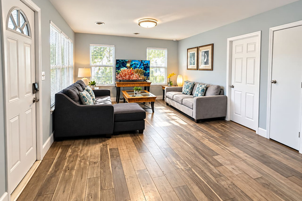 Living Room: Open space with 50 inch TV, perfect for laughter and relaxation after beach days!