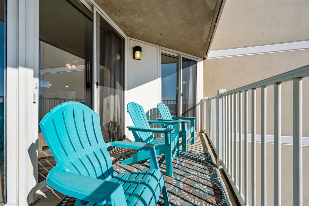 Shaded balcony setup offering comfortable seating and direct access from the living space
