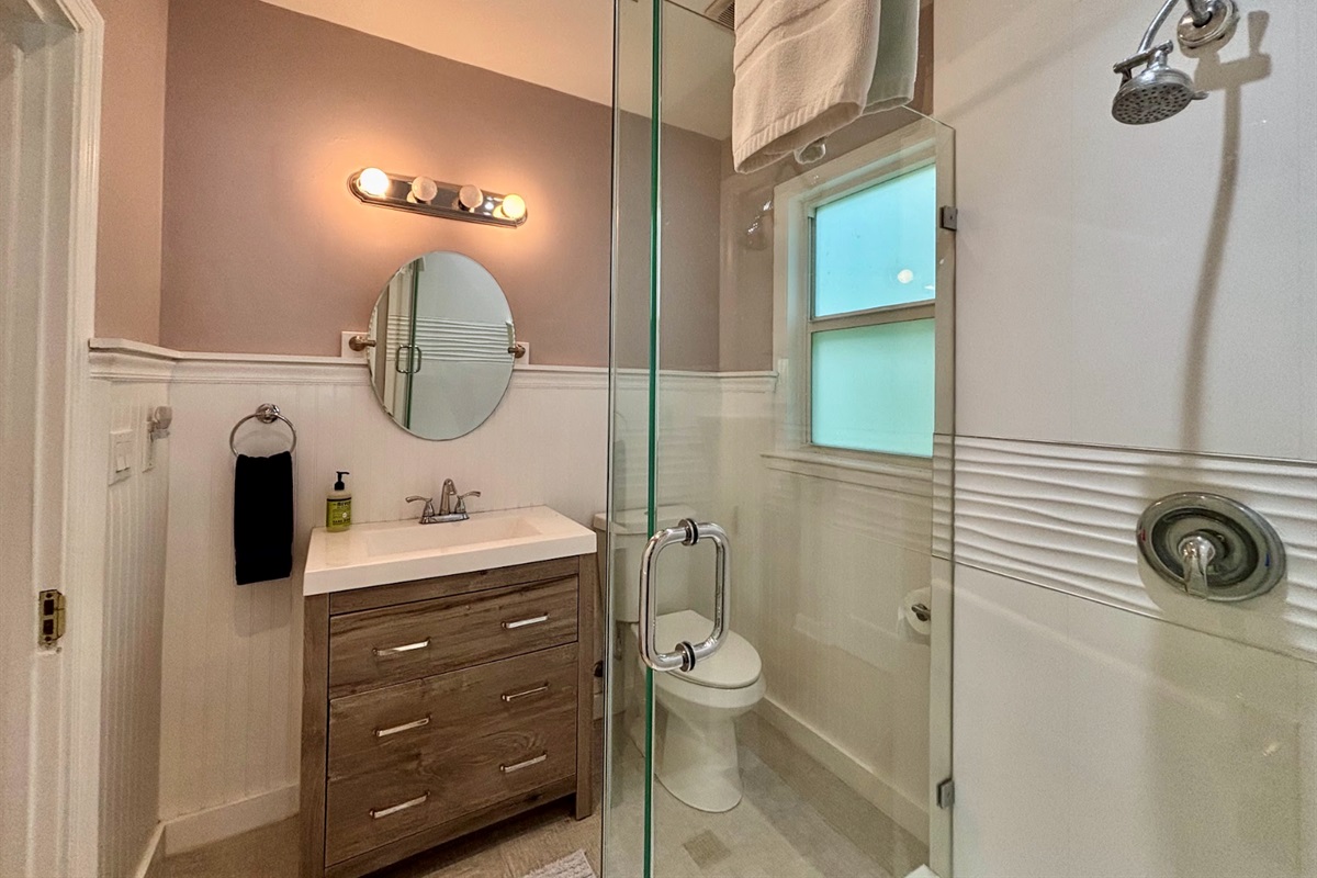The second bathroom can be accessed from the hallway or the bedroom, and is completely renovated with a new shower.