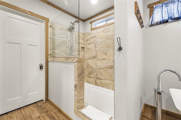 Private primary bathroom with soaking tub and walk in shower