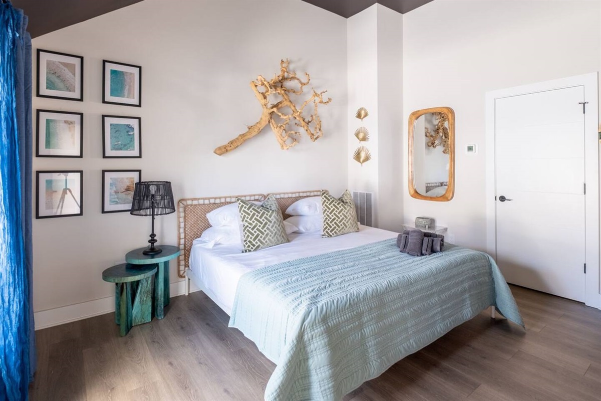 Experience the ultimate in comfort and sophistication in this well-furnished bedroom. Modern art, fresh linens, and kig-sized bed make this bedroom a perfect oasis.