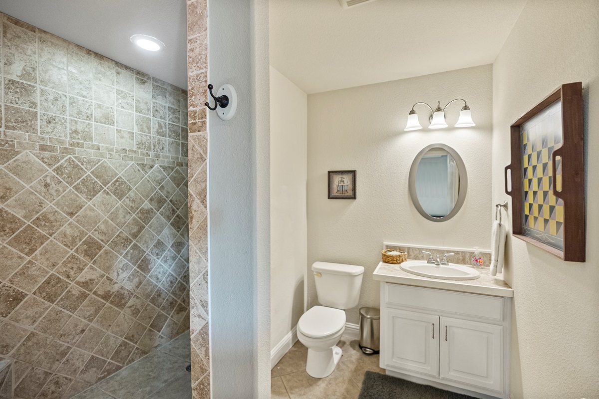 Spacious walk-in shower with easy access from the game room and downstairs bedroom.