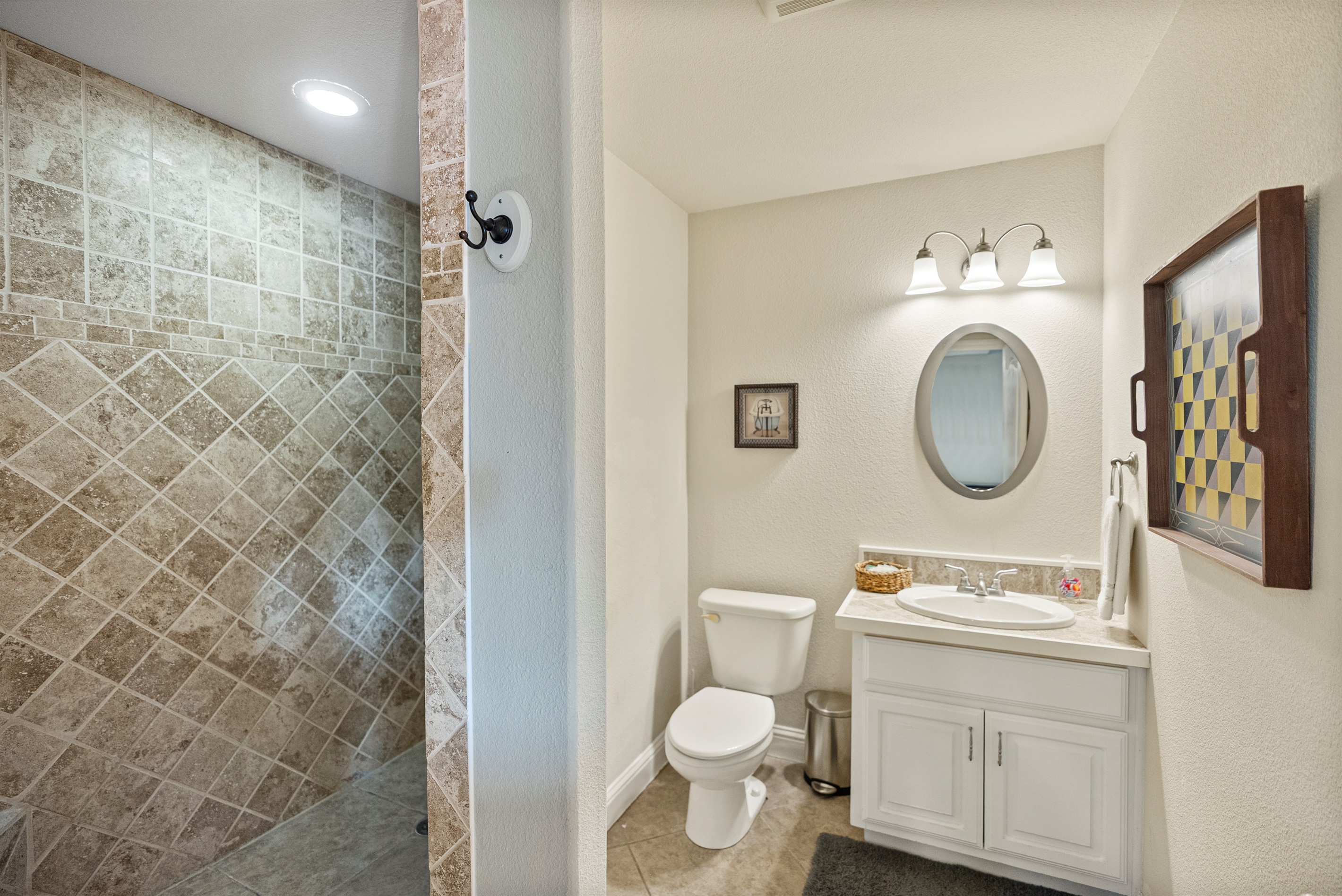 Spacious walk-in shower with easy access from the game room and downstairs bedroom.
