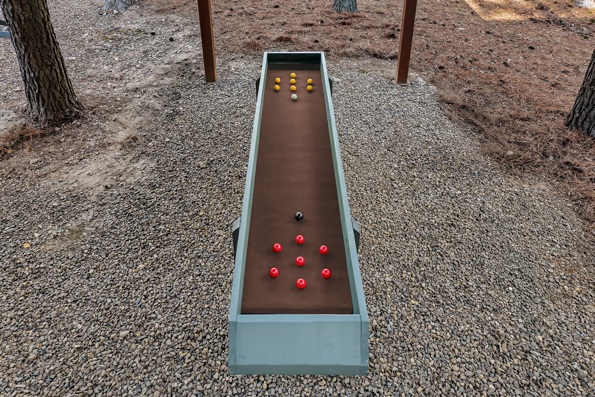 Meet carpetball — an easy-to-learn, all-ages game and another reason the covered play area keeps everyone entertained.