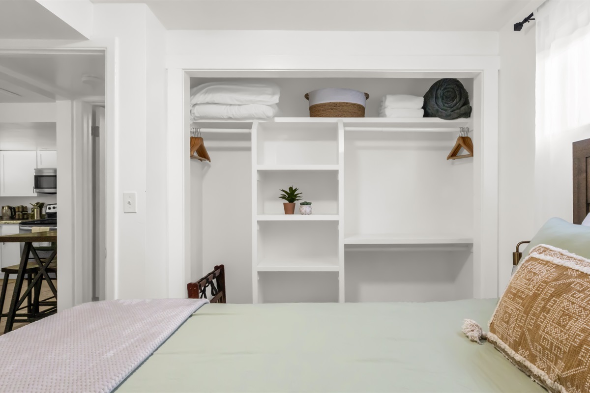 Closet in main bedroom showing extra pillows, sheets, towels, and blanket.