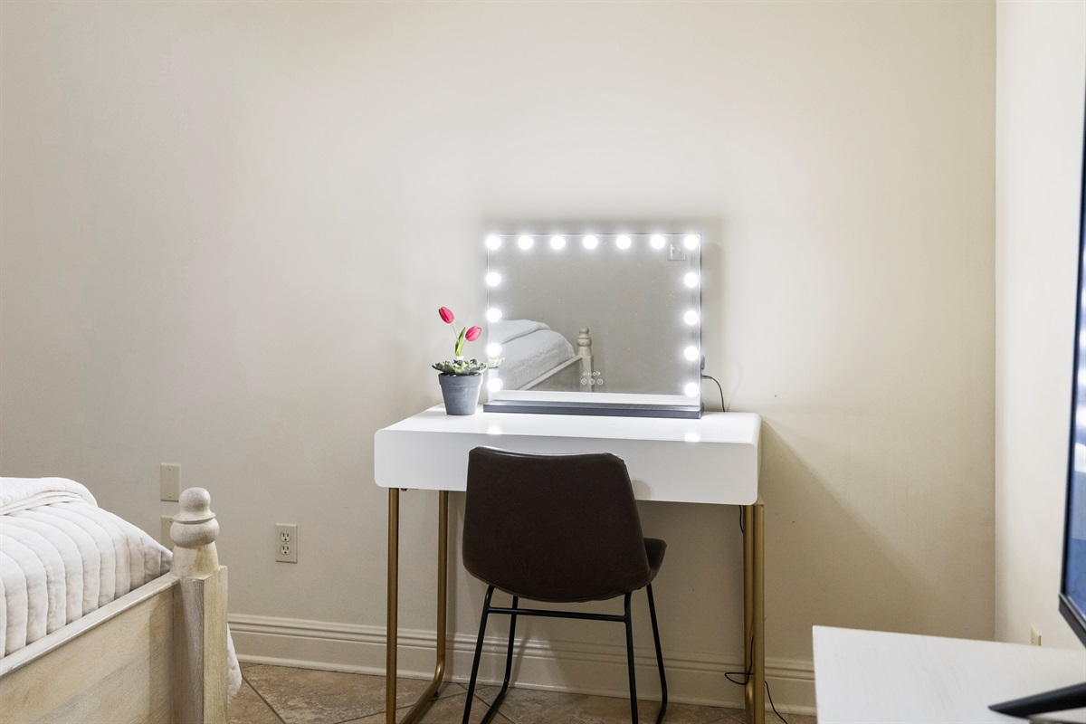 Makeup vanity with lighted mirror for getting ready.