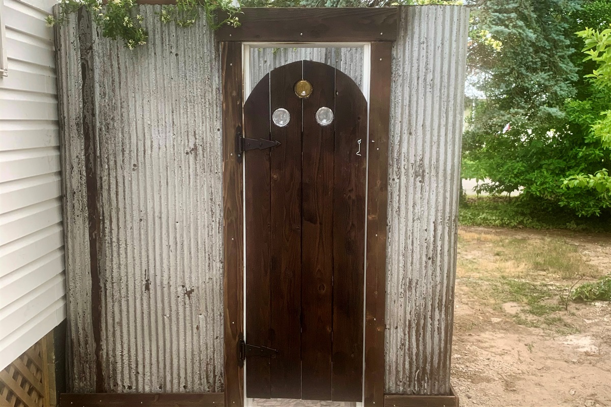 The Outdoor shower is fun with the vintage metal siding... tiled floor, and look there's those circles again