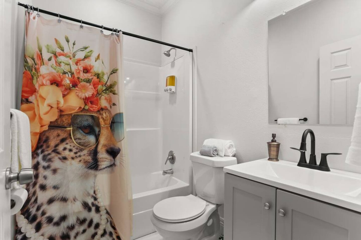 The en suite master bathroom features a tub/shower combo, shampoo, conditioner, & body wash, hair dryer, and plenty of towels.  