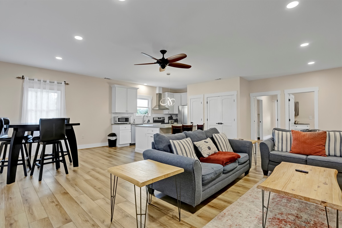 Cozy up in the inviting living room featuring a plush sofa, loveseat, and smart TV.