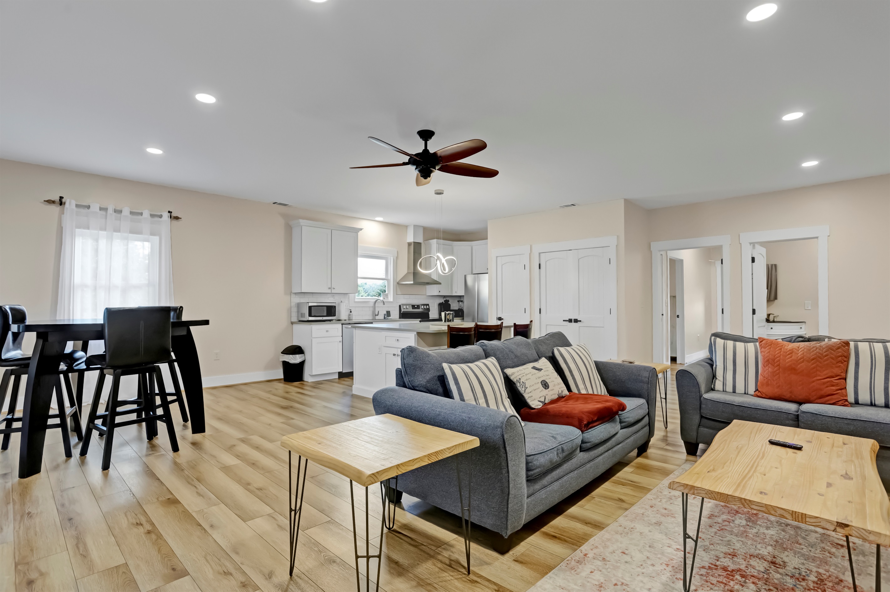 Cozy up in the inviting living room featuring a plush sofa, loveseat, and smart TV.