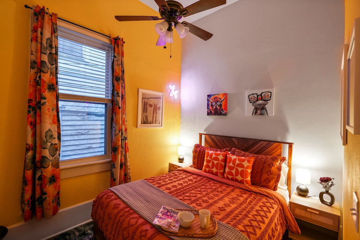 Kick back in the Yellow Room with a memory foam queen bed, dresser, hangers, ceiling fan, and bright, cheerful decor.
