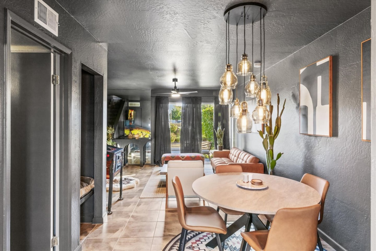 Dining Area with warm lighting, a cozy lounge nearby, and an easy view through the main living space.