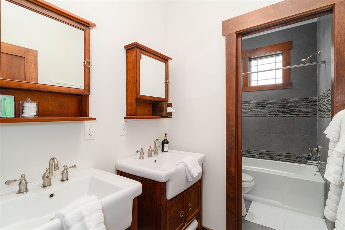 Shared full bathroom with tub/shower combo and clean, updated finishes.