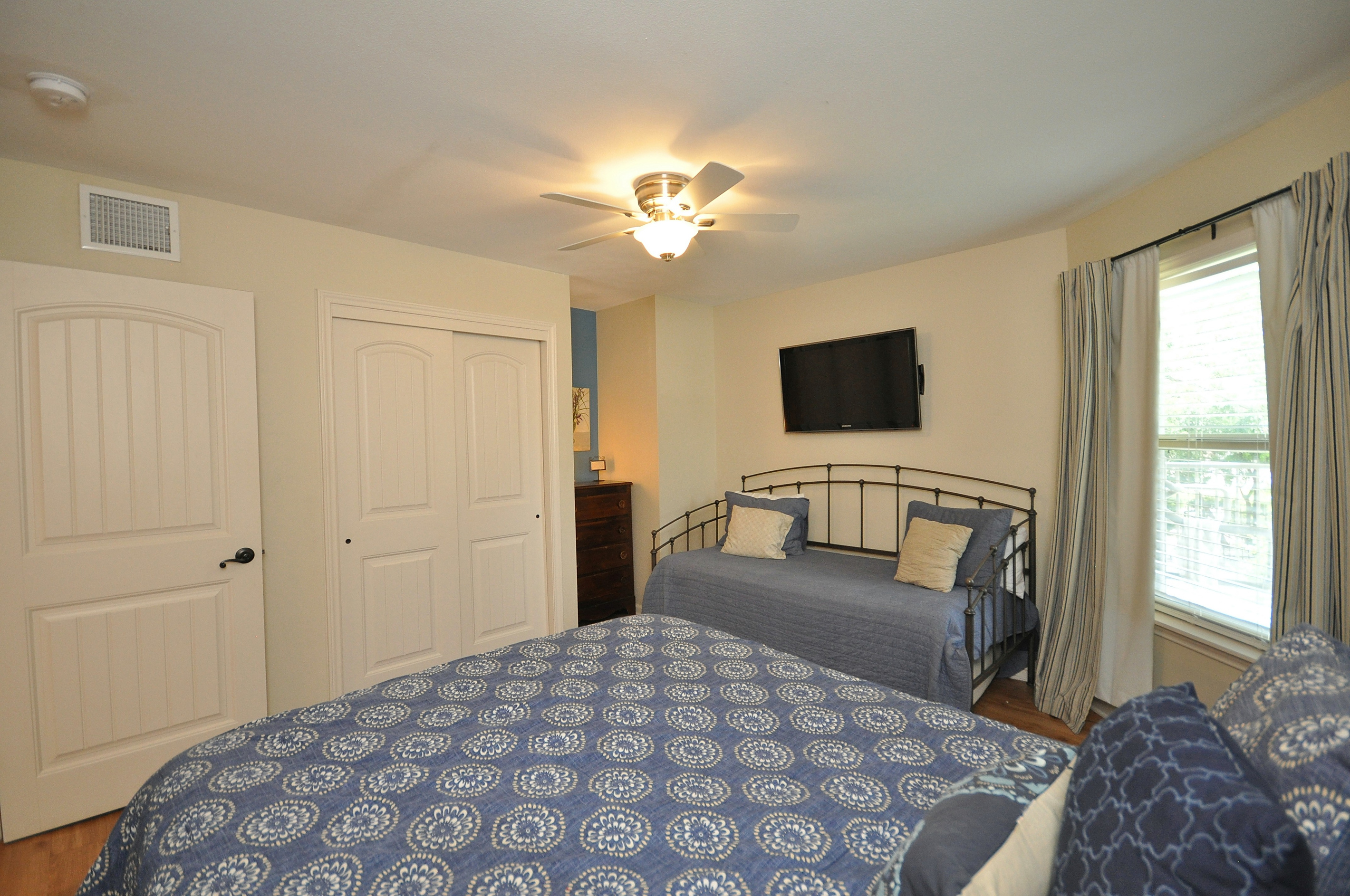 Bedroom has dresser and closet.