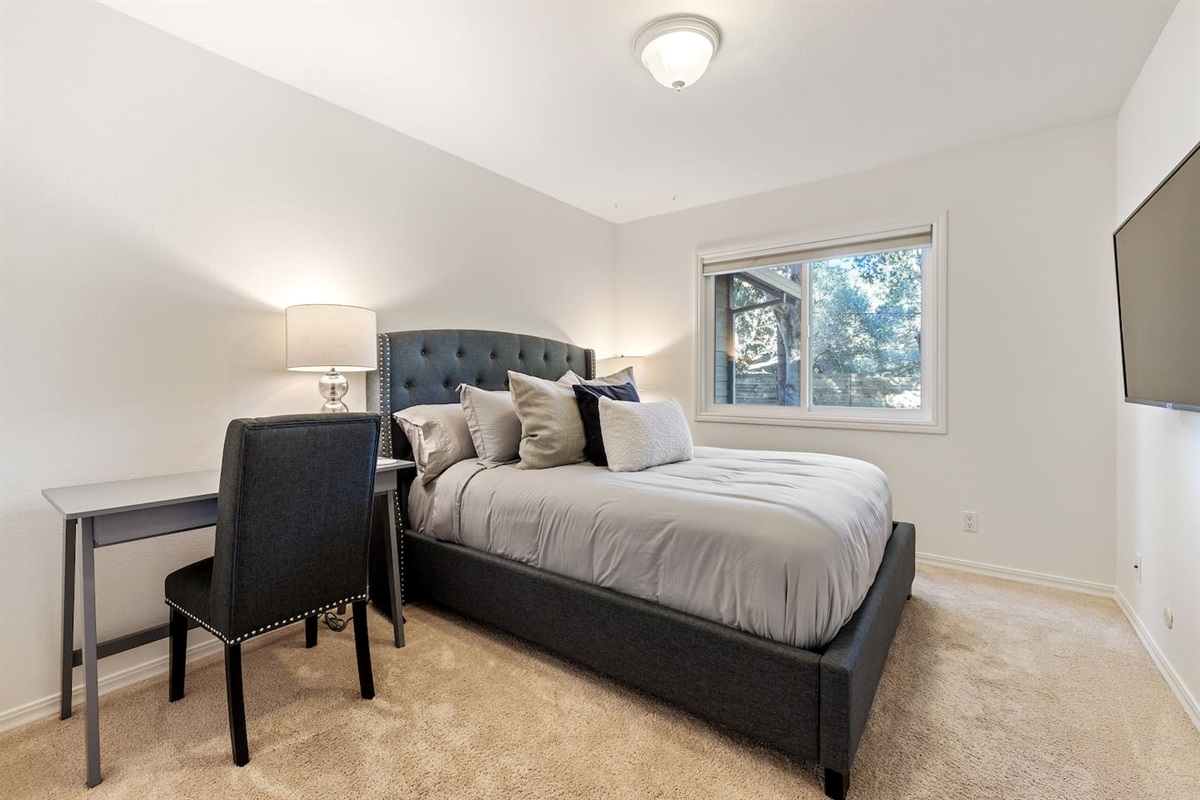 Guest Bedroom: Queen Bed, office desk + chair, 50" 4K TV.