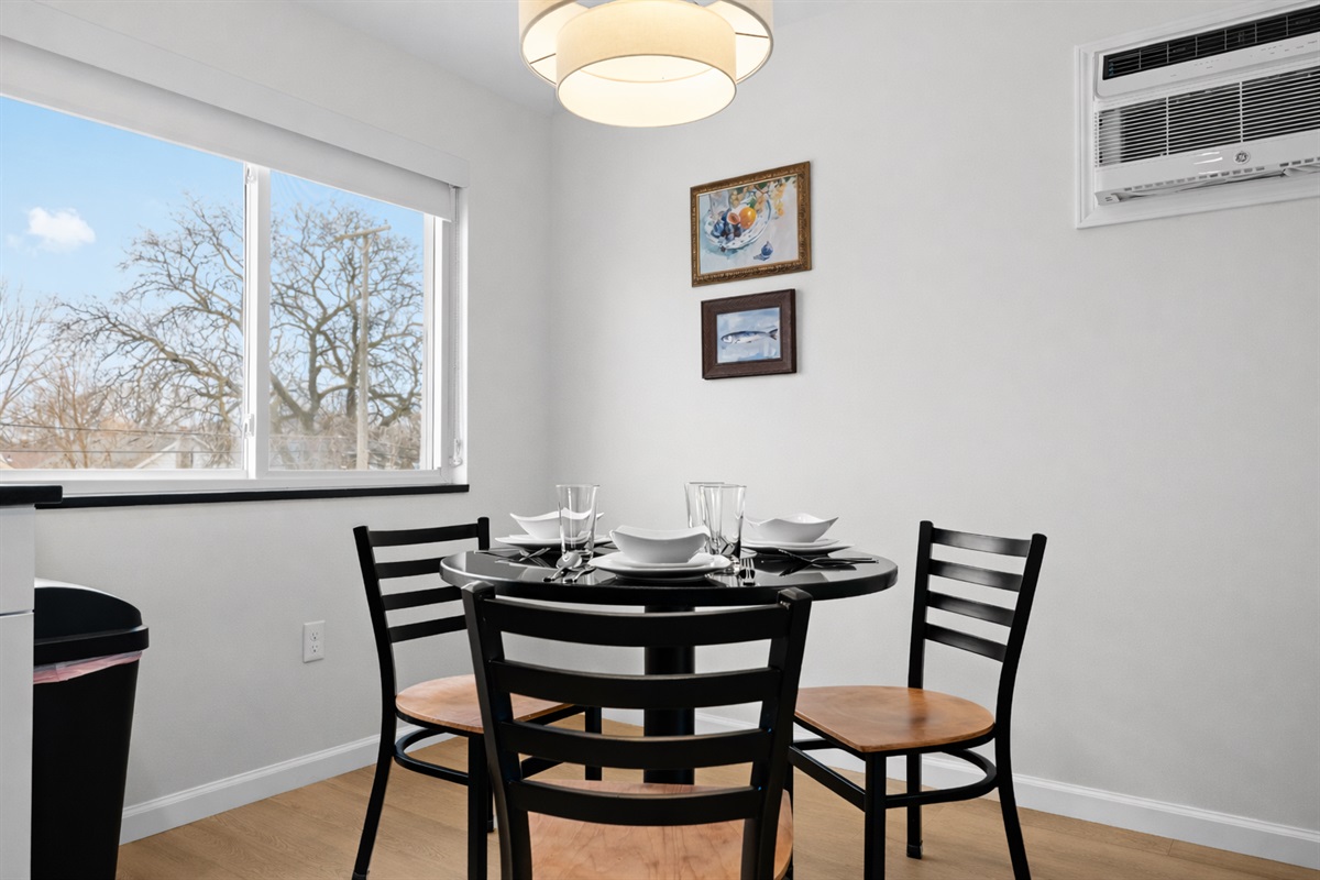 Enjoy meals in this bright dining nook with modern table seating, natural light, and a relaxed setting—perfect for everyday dining or casual gatherings.