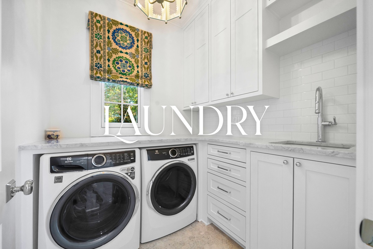 Compact laundry nook with built-in cabinetry.