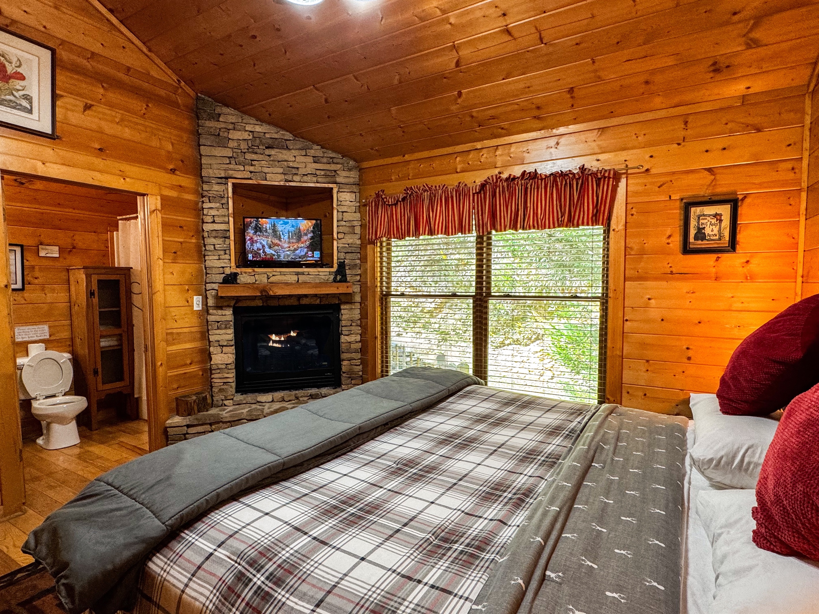King bed, TV, and a fireplace in the master bedroom!