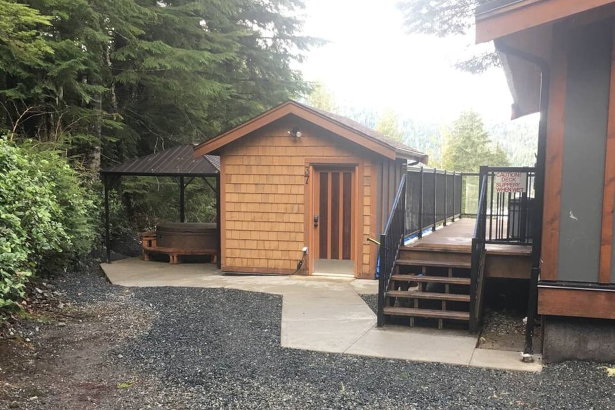 The covered Hot Tub, Bunkhouse, and stairs to the Deck and Cottage entrance
