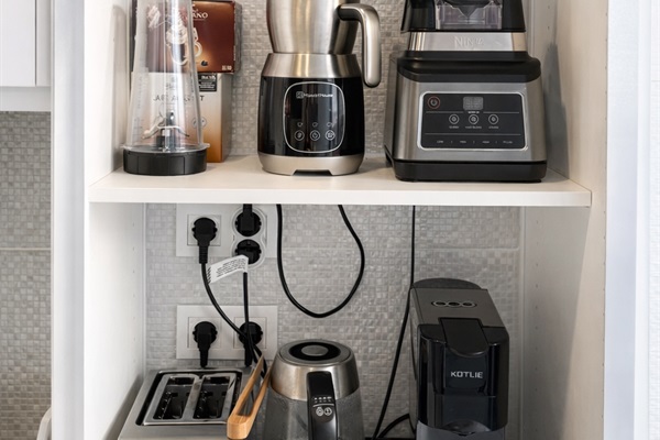 Appliance cabinet with Coffee Kerig capsule Machine, blender, frother, toaster and kettle.