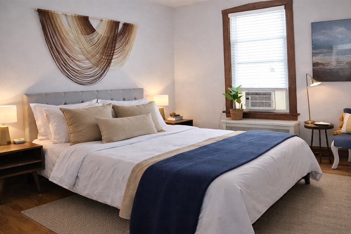 Calm, hotel-quality sleep with plush bedding, privacy and warm hardwood charm. 