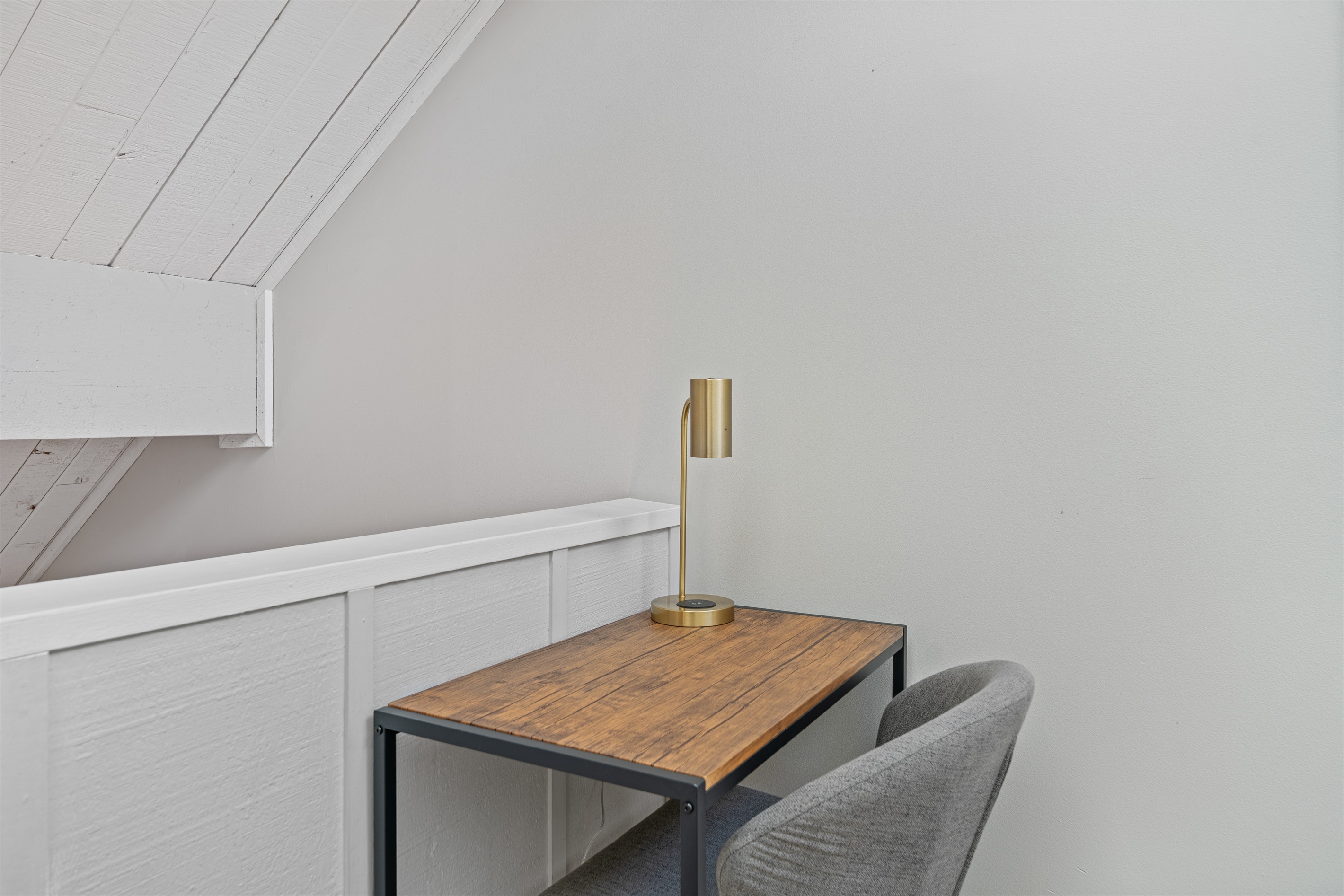 Ideal for remote work is the office area offering a desk, chair and desk lamp 