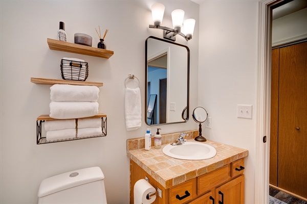 Bright, clean and sleek bathroom with fresh towels and modern essentials, ideal for getting ready in comfort and style.