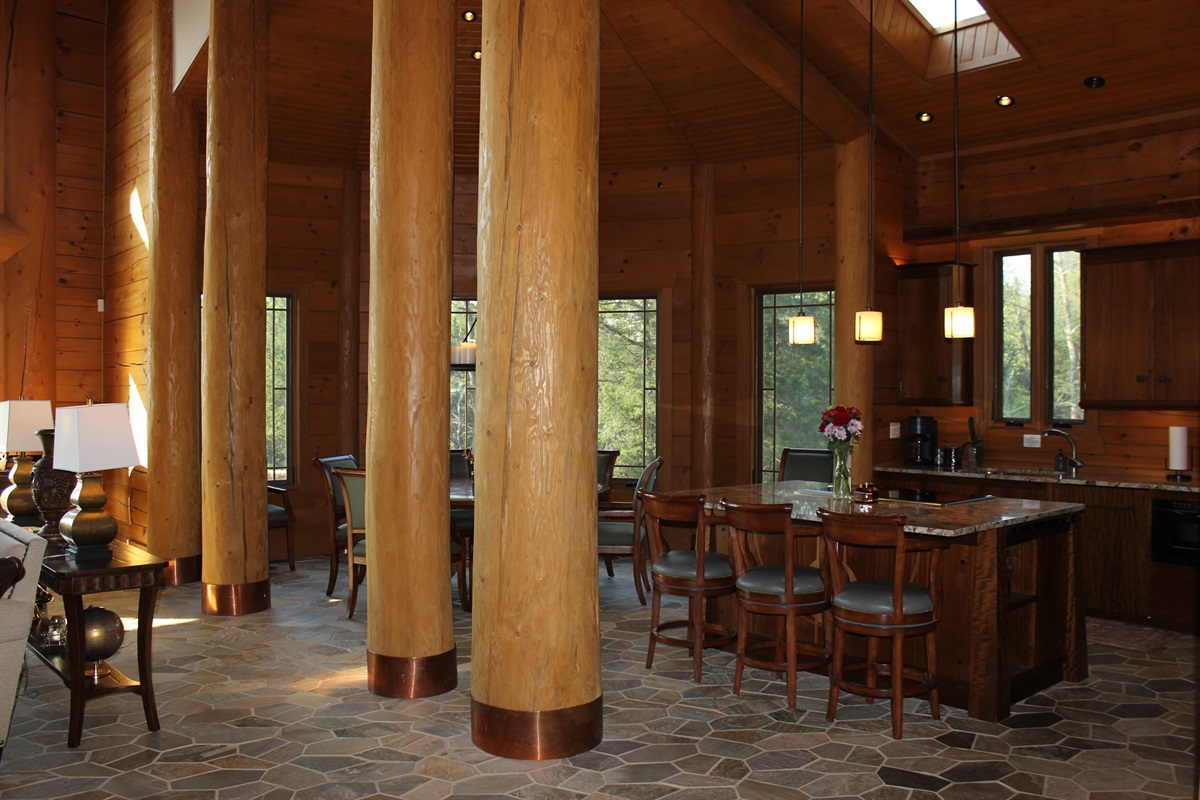 Kitchen view with dining area and large island with three bar stools.