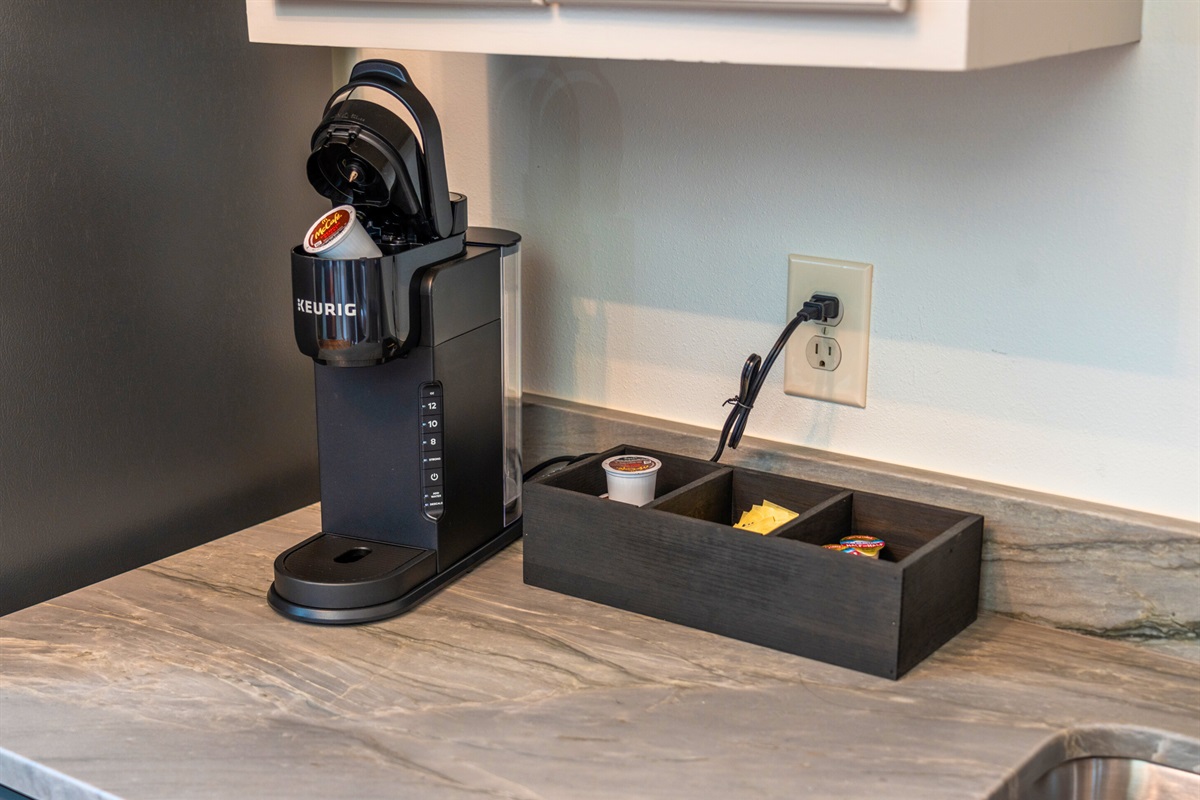 A convenient coffee station, complete with a Keurig and coffee pods, is ready to fuel your mornings or late-night chats.