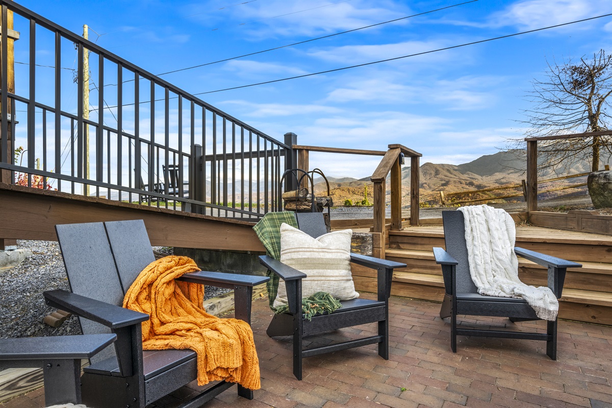 Relax by the outdoor wood-burning fireplace at Signature Stay, where warmth and mountain views create the perfect retreat